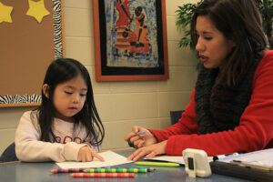 Jenny doing reading interventions with a little girl