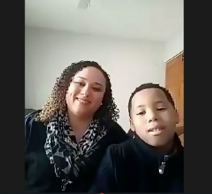 Mother and son smile during legislative testimony about Math Corps